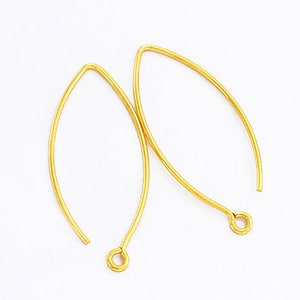 May include: A pair of gold-toned earring hooks. The hooks are made of metal and have a simple, elegant design.