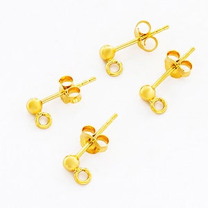 May include: Three gold-toned earring findings with a small ball at the end and a loop for attaching jewellery.