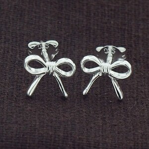 May include: A pair of silver bow-shaped stud earrings. The earrings are marked with "925" on the back.