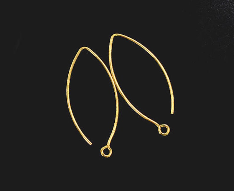 May include: A pair of gold-toned earring hooks. The hooks are made of metal and have a smooth, polished finish.