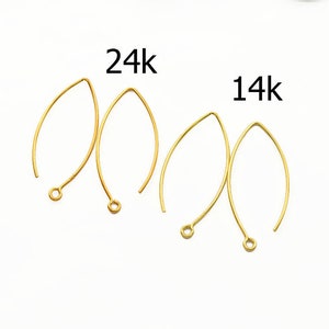 May include: Two pairs of gold earring wires, one pair labeled "24k" and the other labeled "14k".