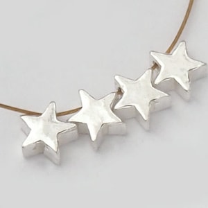 4 of 925 Sterling Silver Little Star Beads 5mm. :th1871