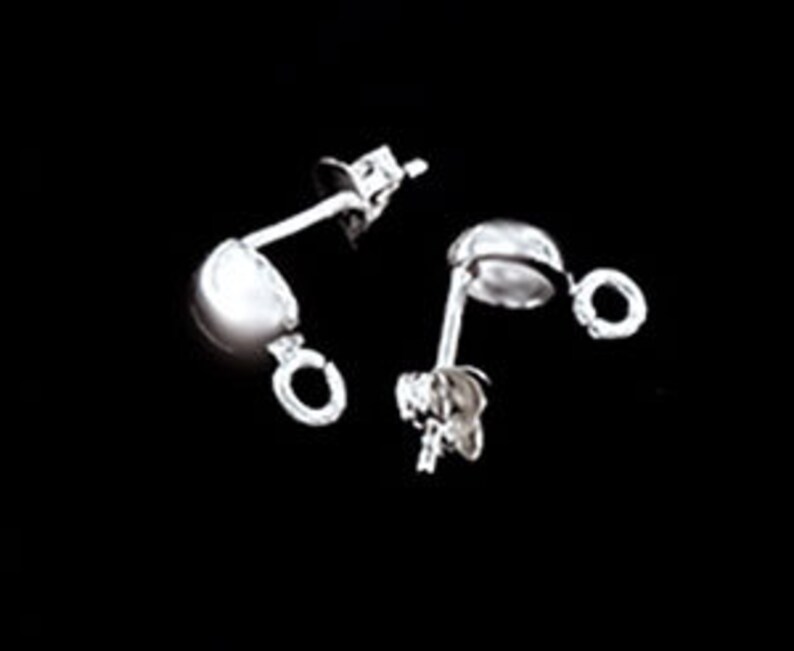 May include: A pair of silver earring findings with a small loop on each side. The findings are designed to be used with beads or other jewelry components.