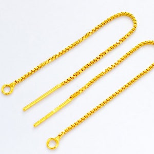 May include: Two gold chain earring extenders with a jump ring at each end. The extenders are approximately 2 inches long.