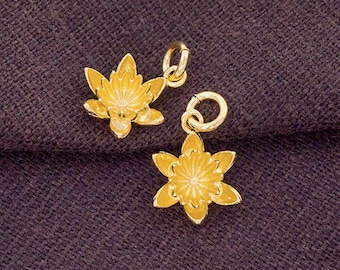 May include: Two gold-colored flower charms with a detailed design. The charms have a loop at the top for attaching to a bracelet or necklace.
