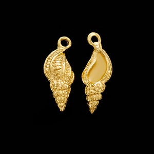 Puede incluir: Dos abalorios de concha de mar de color dorado con un diseño detallado. Los abalorios tienen un bucle en la parte superior para sujetarlos a joyas.