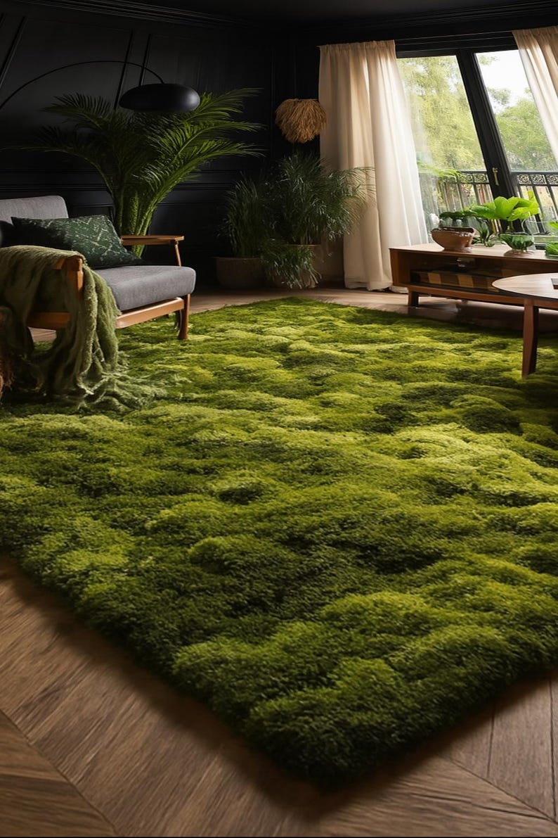 May include: A vibrant green, textured rug dominates the foreground of a living room scene. The rug's plush surface creates a soft, inviting feel. The room features a gray armchair, plants, and a wooden coffee table, creating a cozy and natural atmosphere.