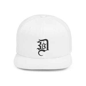 May include: A white baseball cap with a flat peak. The cap has a black, stylized letter "D" embroidered on the front. The design is in a gothic font, giving the hat a classic look.