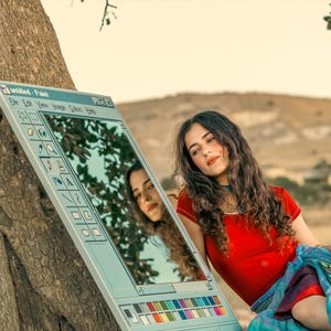 May include: A mirror designed to resemble the classic Windows Paint program interface. The mirror is propped against a tree, reflecting the surrounding environment. The text "untitled - Paint" is visible at the top of the mirror.