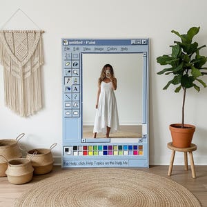 May include: A large, rectangular mirror designed to resemble the classic Windows Paint program interface. The mirror is framed in light blue and features the program's title bar, icons, and color palette. The text "untitled - Paint" is visible. A woman in a white dress is reflected in the mirror.