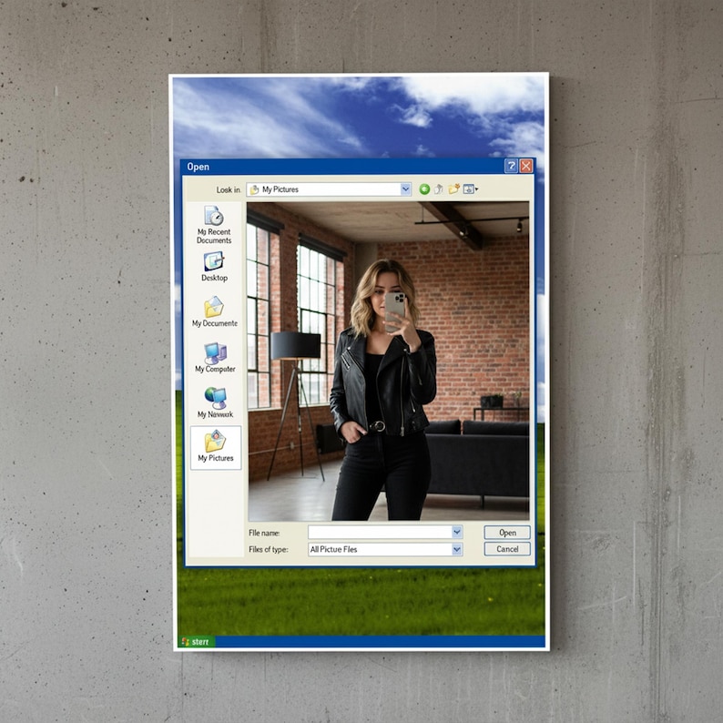 May include: A framed print featuring a retro Windows interface with a woman taking a selfie. The image within the window shows a woman in a black leather jacket and black pants. The background includes a brick wall and a blue sky.
