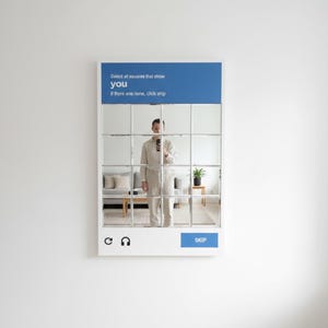 May include: A white framed mirror with a grid of squares, resembling a phone screen. The top blue section reads "Select all squares that show you." A person in a beige jumpsuit is reflected in the mirror, holding a phone. The blue "SKIP" button is visible.