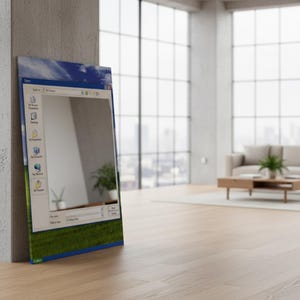May include: A rectangular canvas print leaning against a concrete wall. The print features a retro computer interface with a blue sky and green grass background. The print is in a modern living room setting.