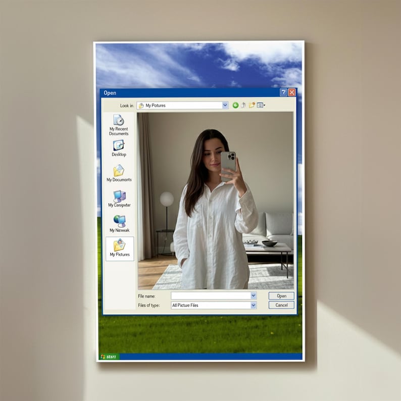 May include: A framed artwork featuring a digital art style. The artwork depicts a Windows XP-style interface with a selfie inside. The interface includes a blue sky and green grass background. The person in the selfie is wearing a white shirt.
