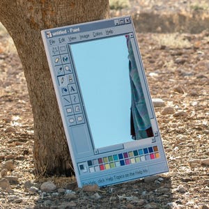 May include: A rectangular mirror designed to resemble the classic Windows Paint application interface. The mirror reflects a blue sky and a portion of a draped fabric. The words "untitled - Paint" are visible at the top.