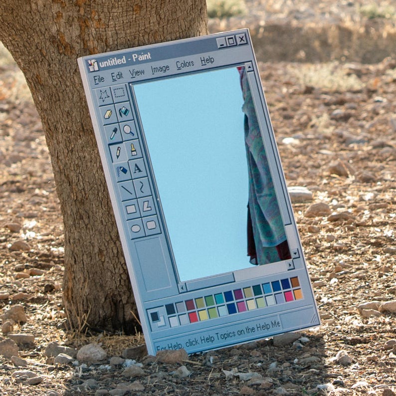 May include: A rectangular mirror designed to resemble the classic Windows Paint application interface. The mirror reflects a blue sky and a portion of a draped fabric. The words "untitled - Paint" are visible at the top.