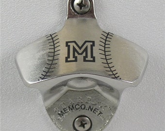 May include: Silver bottle opener with a baseball design and the letter "M" in the center. The opener has a screw on the top and the bottom. The text "MEMCO.NET" is printed on the bottom.
