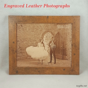 May include: A framed engraved leather photograph of a wedding couple in front of a stone archway. The photo is in sepia tones and the couple is dressed in formal attire. The frame is made of wood and has a rustic finish. The text "Stefania & Vinni September 2018" is engraved on the leather.