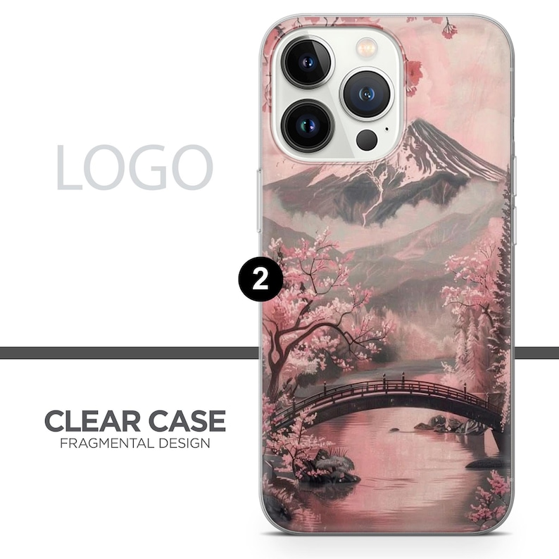 May include: Clear phone case with a Japanese landscape design. The case features a pink and grey mountain scene with a bridge over a body of water and cherry blossom trees. The text "CLEAR CASE FRAGMENTAL DESIGN" is printed on the case.