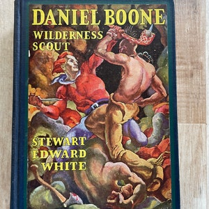 May include: A vintage book cover with a colorful illustration of a man fighting a Native American. The title is "Daniel Boone Wilderness Scout" and the author is "Stewart Edward White".