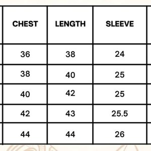 May include: A size chart in a grid format, with measurements in centimeters. The chart includes sizes S, M, L, XL, and XXL, with corresponding chest, length, sleeve, and shoulder measurements. The text "SIZE (CM)" is at the top.