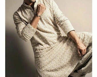 May include: Beige embroidered kurta and matching pants. The long-sleeved kurta features intricate floral embroidery along the collar, cuffs, and hem. The outfit is paired with black shoes. The text "Refrence picture" is visible in the background.