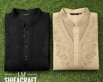 May include: Two embroidered kurta shirts, one black and one beige, are displayed on a green surface. The shirts have a mandarin collar and button-down front. The text "AM SHIFACRAFT" is visible at the bottom.