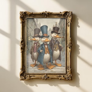 May include: A framed print depicting three ducks dressed in Victorian clothing, including top hats and coats, set against a street scene. The artwork is presented within an ornate gold frame, enhancing the vintage aesthetic of the illustration.