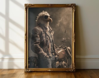 May include: Framed artwork featuring an eagle-headed figure in a leather jacket and sunglasses, leaning against a motorcycle. The artwork has a sepia tone, with a gold ornate frame, and is set against a neutral background.