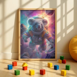 May include: A framed print featuring a koala in a colorful astronaut suit floating in space. The artwork has a vibrant, cosmic background with planets and nebulas. Wooden blocks in various colors are scattered on the floor in front of the frame.