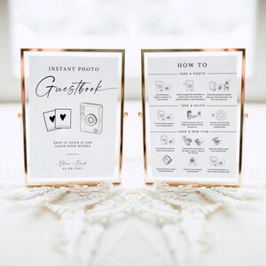 May include: Two rose gold framed signs with white backgrounds. The left sign reads Instant Photo Guestbook, Snap it, stick it and leave your wishes, with camera and heart icons. The right sign provides How To instructions for camera use.