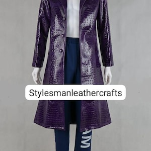 May include: A long, purple, textured coat with a notched collar and button closure. The coat is paired with navy blue trousers and a white shirt. The text "Stylesmanleathercrafts" is visible on the image.