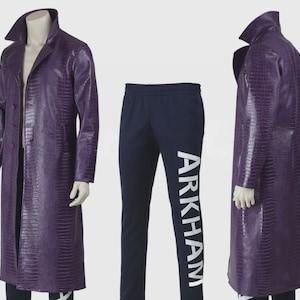 May include: A purple, textured, long coat with a notched collar and button closure, paired with navy blue sweatpants. The sweatpants have the word "ARKHAM" printed vertically in white on the left leg. The coat is displayed on a mannequin.