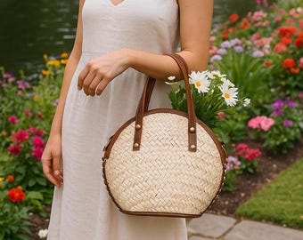 Borsa in paglia intrecciata fatta a mano: borsetta rotonda in stile boho con manici in pelle.