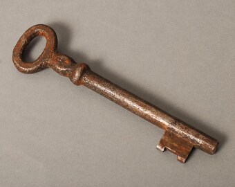 Antique metal skeleton key. Old rustic patina
