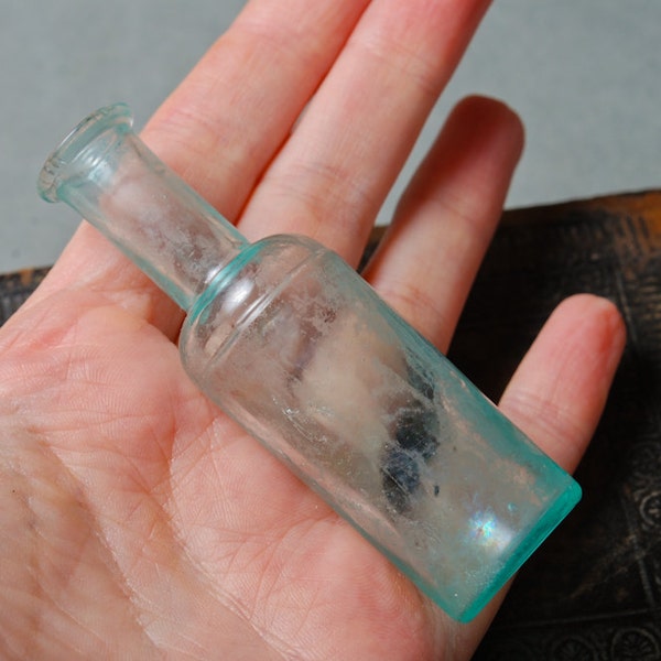 Antique small blue glass bottle, medical or laboratory bottle.