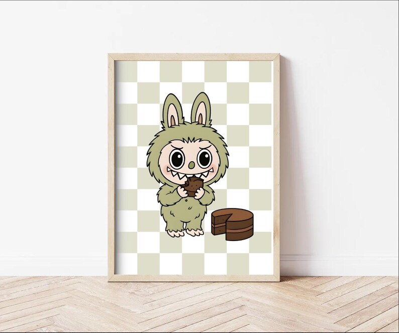 May include: A framed print featuring a cartoon monster in a green bunny suit, eating a piece of chocolate cake. The background is a checkered pattern in light green and white. The artwork is whimsical and playful.