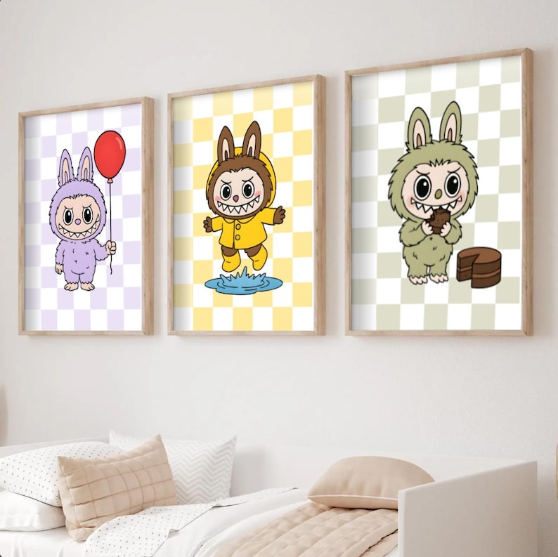May include: Three framed art prints featuring cartoon characters in bunny costumes. One holds a red balloon, another is in a yellow raincoat, and the third holds a slice of cake. Each character is set against a checkered background.