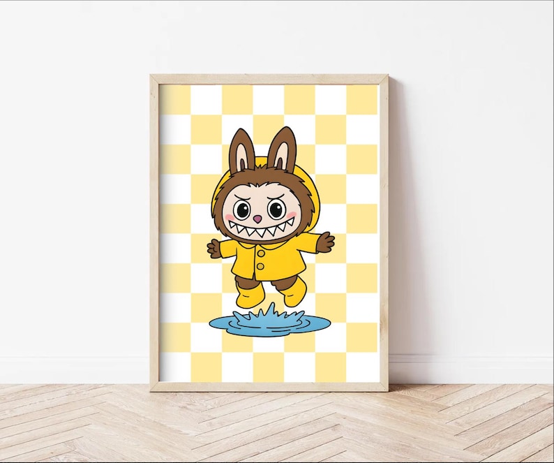 May include: A framed cartoon print of a creature in a yellow raincoat and boots, with bunny ears, jumping over a puddle. The background is a yellow and white checkered pattern. The artwork is in a wooden frame.