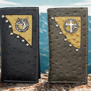 May include: Two leather wallets, one black and one brown, with decorative metal accents. Each wallet features a textured surface, a light-colored patch, and a metal emblem. The black wallet has a horse emblem, and the brown wallet has a cross emblem.