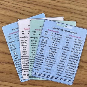 May include: A stack of four cards displaying normal lab values for adults. Each card has a different color background and lists hematology and electrolyte values with their respective ranges. The cards are arranged at a slight angle.