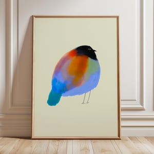 May include: A framed wall art print featuring a stylised, rounded bird illustration. The bird has a solid black head, a vibrant body with blended patches of orange, red, and blue, and thin, simple black lines representing its two legs.