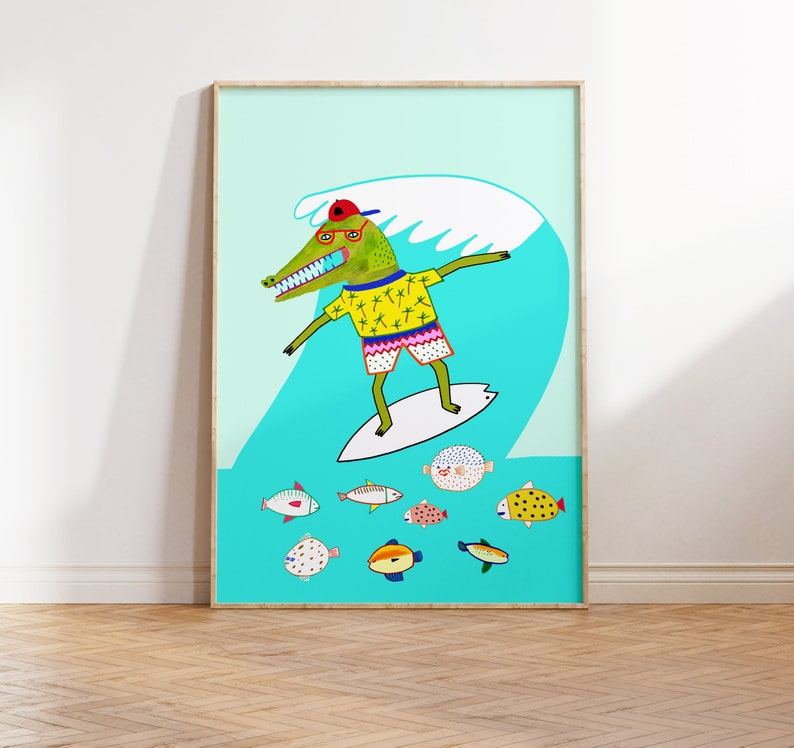 May include: A green crocodile wearing a red hat, yellow shirt, and blue shorts is surfing on a white surfboard in a blue ocean. The crocodile is smiling and has a white wave behind it. There are several colorful fish swimming around the crocodile.