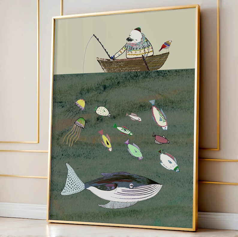 May include: A framed illustration of a polar bear wearing a sweater and a hat, fishing from a boat. The boat is floating above a green ocean with a whale swimming below. The ocean is filled with colorful fish and jellyfish.