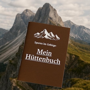 May include: A brown journal featuring the text "Spuren im Gebirge - Mein Hüttenbuch" and a mountain graphic. The journal is set against a backdrop of a mountain range.