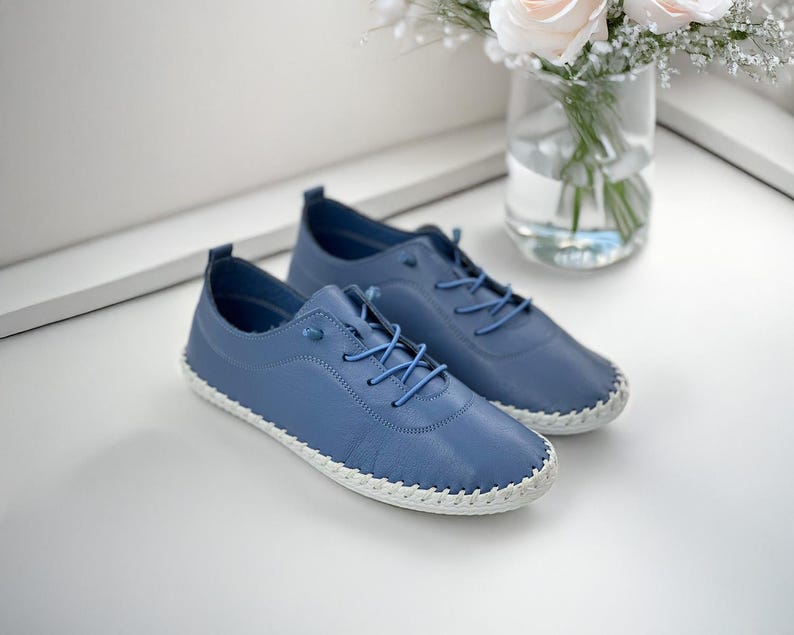 Minimalist white leather shoes close-up view