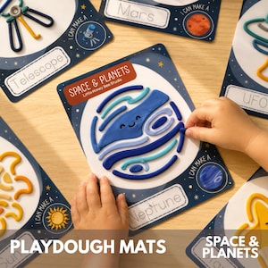 May include: A set of space and planet themed playdough mats featuring colorful illustrations of a telescope, Mars, a UFO, the sun, Neptune, and a star. Each mat includes a label and a space to create shapes with dough, showing a blue Neptune design.