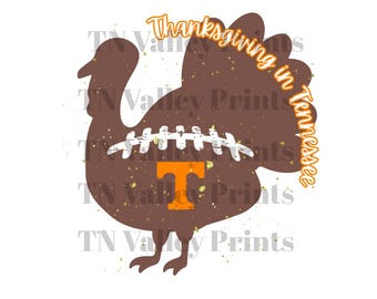 May include: A brown turkey silhouette with a football design in the center and the letter "T" in orange. The text "Thanksgiving in Tennessee" is in orange script around the turkey's tail feathers. Gold flecks are scattered around the turkey.