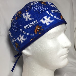 May include: Blue and orange patterned surgical scrub hat with the text "UK Wildcats" and "Go Big Blue".