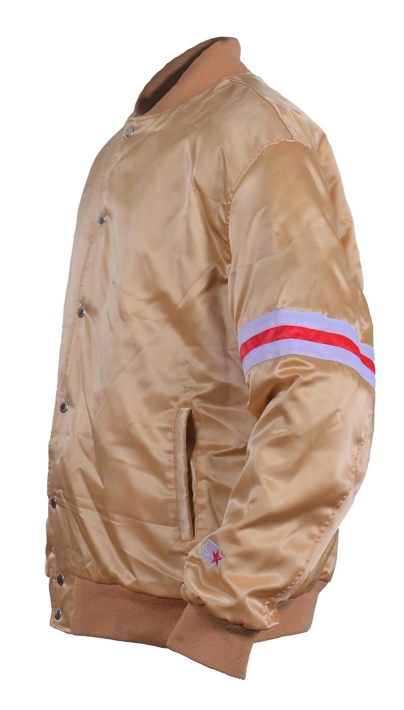 Side view of golden satin varsity jacket shiny bomber with red and white stripes and star patch on sleeve